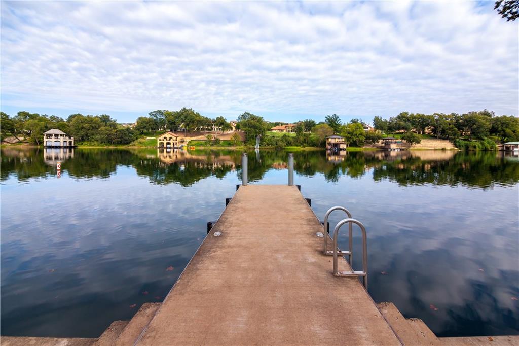 Apache Shores day dock reaching out into Lake Austin with boat docks and Hill Country homes across the water